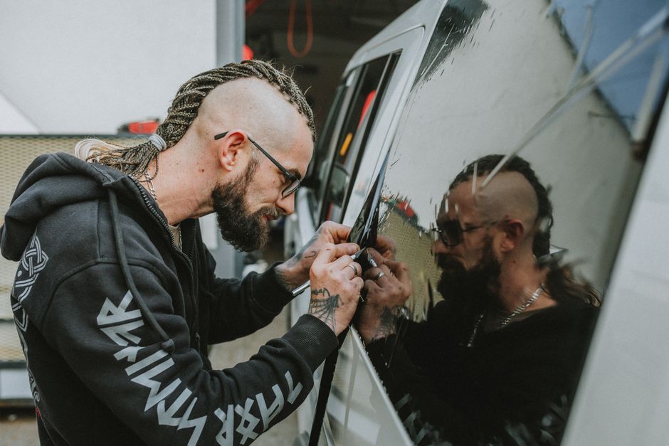 Technician installing auto glass carefully